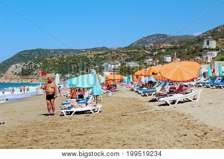 July, 2017 - Vacationers bathe in the sea and sunbathe in the sun on Cleopatra Beach (Alanya, Turkey).