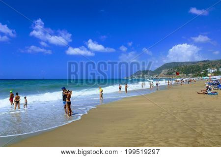 July, 2017 - Vacationers bathe in the sea and sunbathe in the sun on Cleopatra Beach (Alanya, Turkey).