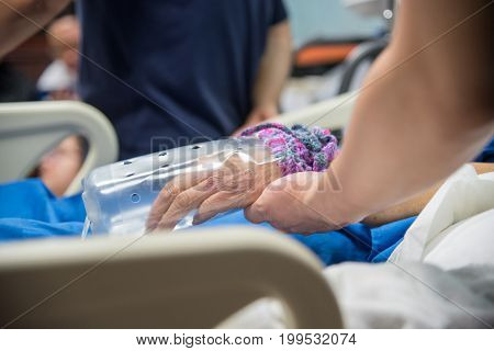 Patient In The Hospital And Holding A Hand