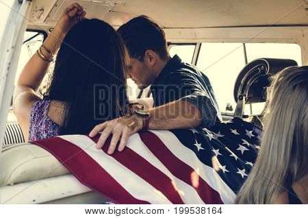 People Sitting in a Front Seat with American Flag on Rear Seat