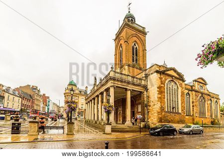 Northampton, UK - Aug 08, 2017: Cloudy rainy day view of All Saints Church in Northampton Town Centre.