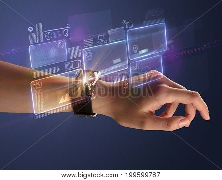 Female hand wearing smartwatch with statement labels around and dark background