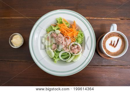 flat lay tuna salad with lettuce and coffee on wood table