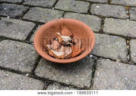earthenware flower pot with cracked pieces inside used for gardening