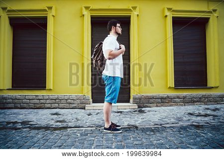 man stand on cit street closed store on background