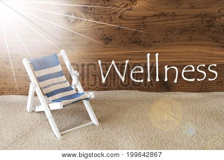 Sunny Summer Greeting Card With Sand And Aged Wooden Background. English Text Wellness. Deck Chair For Holiday Or Vacation Feeling.