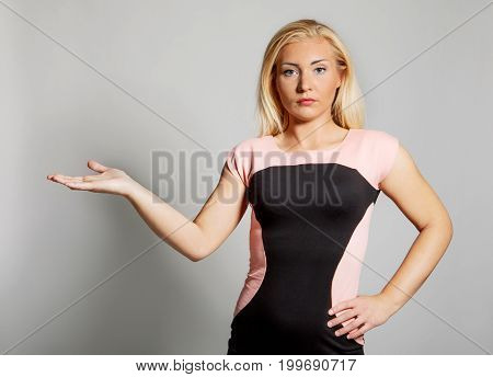 The portrait of young woman showing on side.