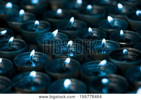 Nightlight. Lighted tea light candles at night with a silver blue tone. Cool mood lighting.
