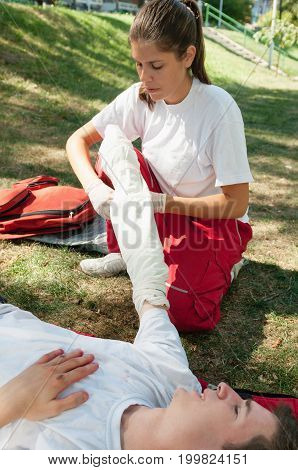First Aid Treatment Of Injured Patient, Bandaging Arm, Outdoors Image, Color Image, Focus On Arm