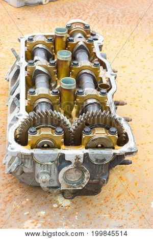 Cylinder head on rusty steel. Vertical image