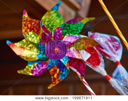 Colorful toy weathercock vane in fast motion turning in the wind