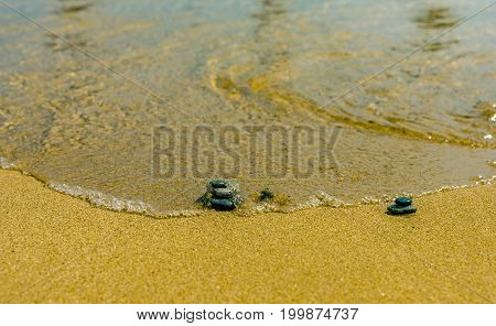 Balance stone on river coast Sand water pebbles relax