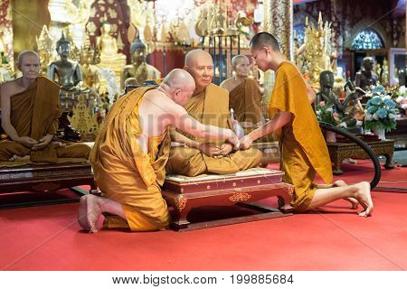 Buddhist Monk Clean And Remove Dust From Monk Waxwork Robe