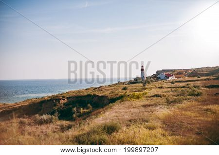 The lighthouse over the sea near the house