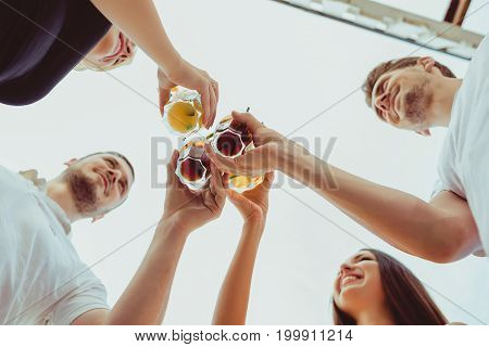 Friends having fun at the bar outdoors, drinking cocktails. Summer bar