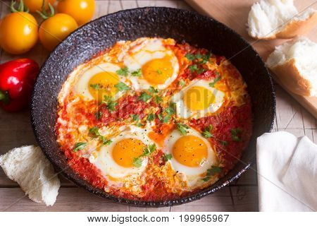 Shakshuka With Bread On A Wooden Table. Middle Eastern Traditional Dish. Homemade. Selective Focus.