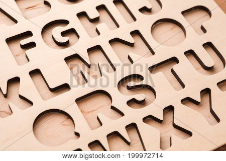 English alphabet stencil closeup, empty sorter for kids development