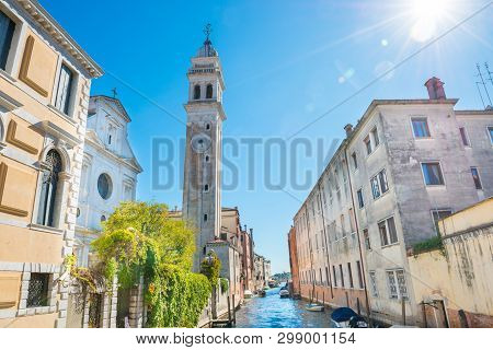 View Of Campanile Of Church San Giorgio Dei Greci And Canal On A Sunny Day. Venice, Italy