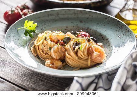 Pasta Spaghetti On Plate And Pan With Shrimp Tomato Sauce Toatoes And Herbs. Italian Or Mediterranea