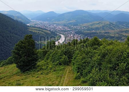View To The Town Between The Mountains. The River Flows Between The Mountains With Forest. Mizhhirya