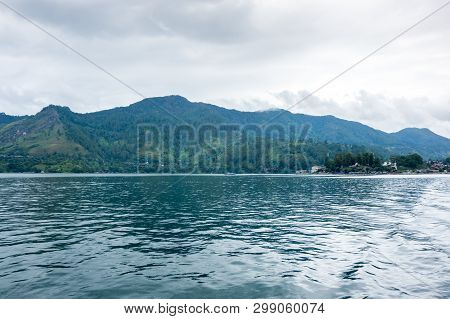 Lake Toba Is A Large Natural Lake Occupying The Caldera Of A Supervolcano, Located In The Middle Of 
