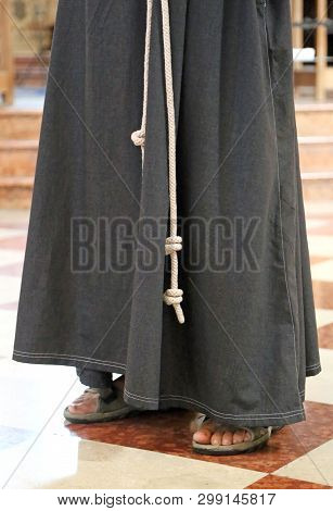 Franciscan Friar With Sandals And Brown Habit In The Church