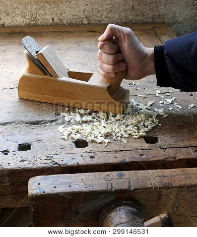 Hand Of Worker  In The Carpentry Workshop With A Plane
