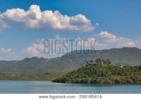 Clouds Over Mountains With Lake In A Foreground