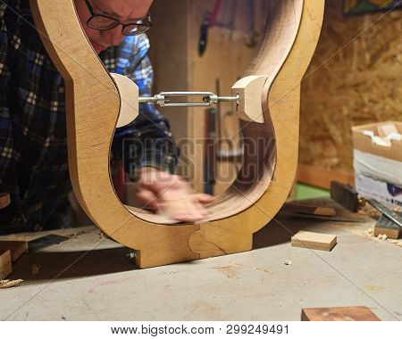 The Process Of Making A Classical Guitar. Surface Treatment With Sandpaper.