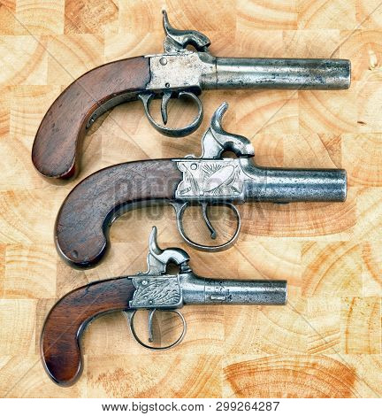 Three Antique Muff Percussion Pistols Made Around 1850.