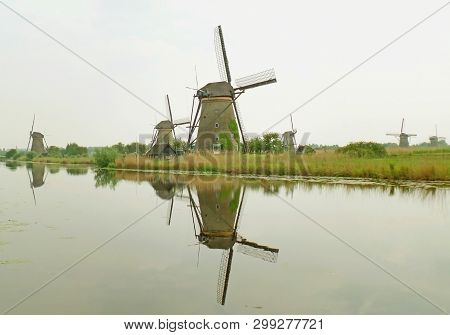 Reflections Of The Historic Windmills Group At Kinderdijk, Molenwaard, Netherlands