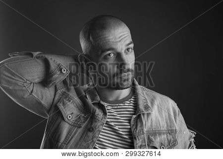 Calm Glance Of Handsome Bristled Man Looking Away With His Arm Behind His Back Being Deep In Thought