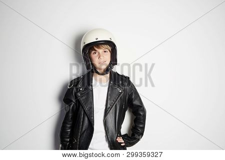 Portrait Of Young Cool Beautiful Teen Kid In Black Leather Jacket And White Moto Helmet Smiling On W