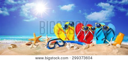 Tropical beach with sunbathing accessories, summer holiday background. Travel and beach family vacation