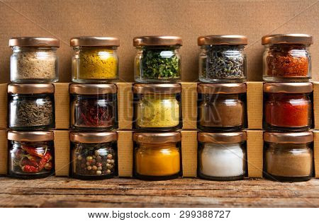 Large Collection Of Spices In Small Jars On The Shelf