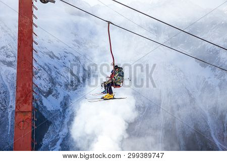 Dombai, Russia - January 3, 2014: People Are Lifting On Open Lft High Up In Caucasus Mountains