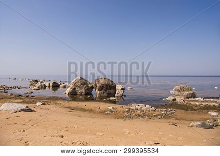 Stones Balance On The Beach. Place On Latvian Coasts Called Veczemju Klintis