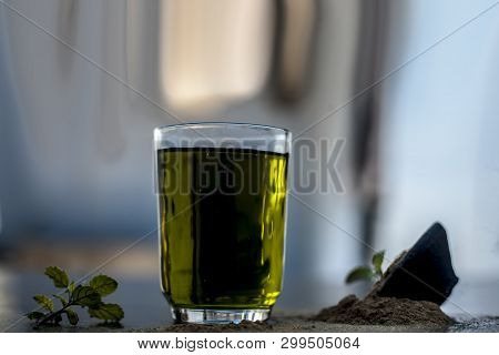 Ayurvedic Herb Brahmi Or Waterhyssop With Its Herbal And Beneficial Extract  In A Transparent Glass