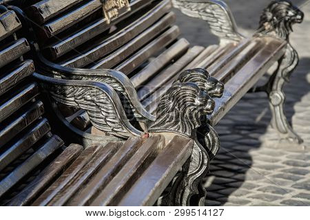Old Bench With Iron Lions In The Center Of Lviv