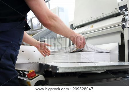 Paper Trimming On A Guillotine. Printing House. Cutter For Cutting Paper.