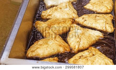 Belyash Fry In Boiling Oil Outdoors. Cooking Pies With Meat. Tatar Cuisine.