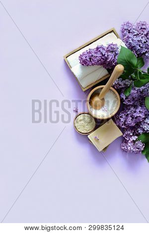 Spa And Massage Products With Lilac On Purple Background