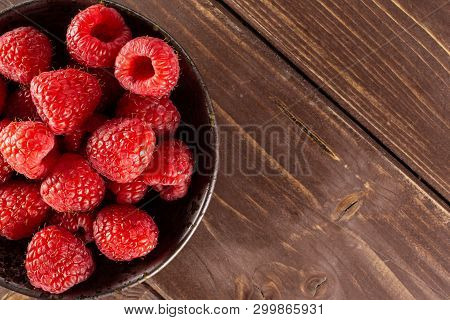 Lot Of Whole Fresh Red Raspberry On Grey Ceramic Plate Flatlay On Brown Wood