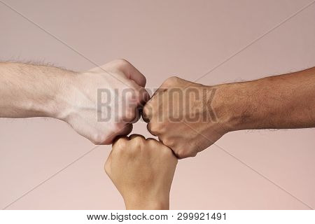 Hand Fist Bumping Isolated. 3 People Bumping Their Fist. Teamwork And Success Concept.