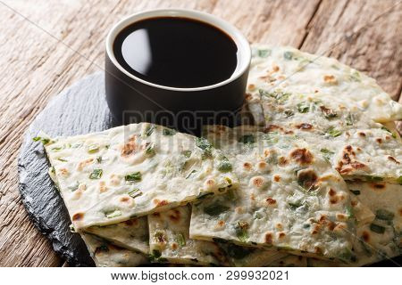 Chewy, Flaky, And Savory Scallion Pancakes With Sauce Close-up On A Board. Horizontal