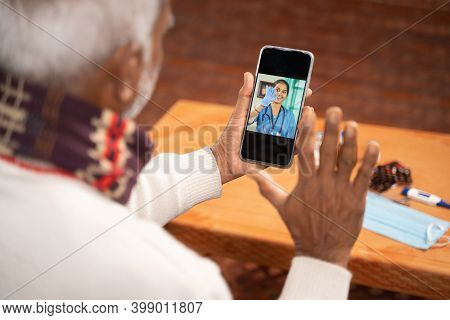 Shoulder Shot Of Old Man On Video With To Doctor On Mobile Phone - Concept Of Nurse Online Chat, Tel