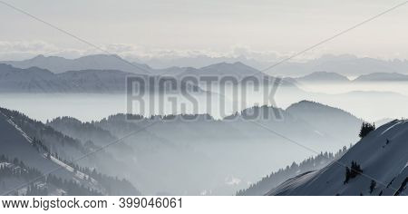 Snow Mountains Panorama In Low Lying Inversion Valley Fog. Silhouettes Of Foggy Mountains. Scenic Sn