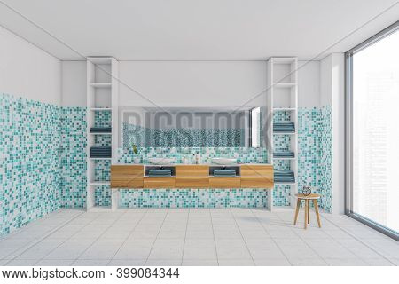 White And Sea-green Bathroom With Two White Sinks And Mirror. Wooden Drawers And Shelves With Towels