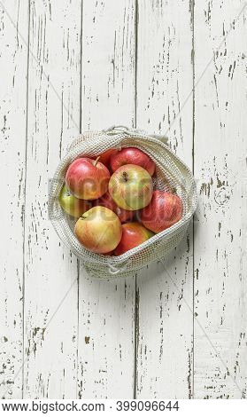 Organic Apples In Reusable Eco Friendly Natural Bag On The White Wooden Background