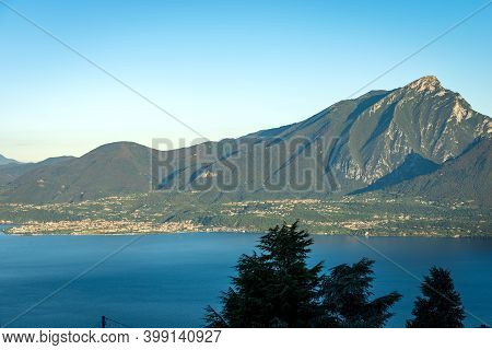 Aerial View Of The Lake Garda And Italian Alps With The Peak Of Monte Pizzocolo And The Small Town O